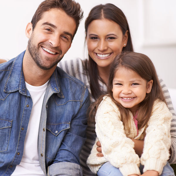 smiling family of three
