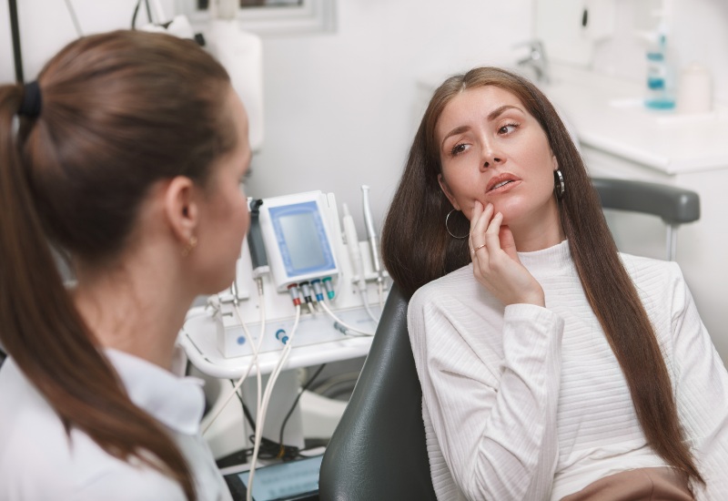 A patient consulting a dentist for emergency dental care in a clinic in Kenosha, WI
